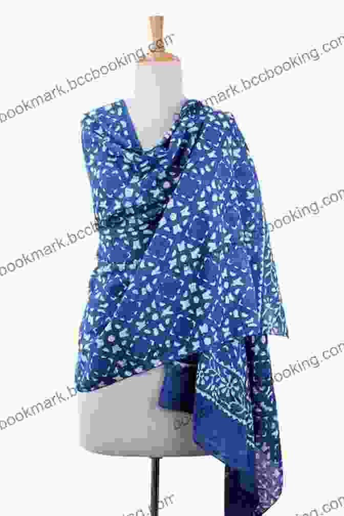 A Beautifully Gift Wrapped Indigo Impressions Wrap Shawl, Adorned With A Delicate Ribbon And A Handwritten Note, Placed On A Cozy Bed With Fairy Lights. Indigo Impressions Crochet Pattern 101 3 In 1 Wrap / Shawl