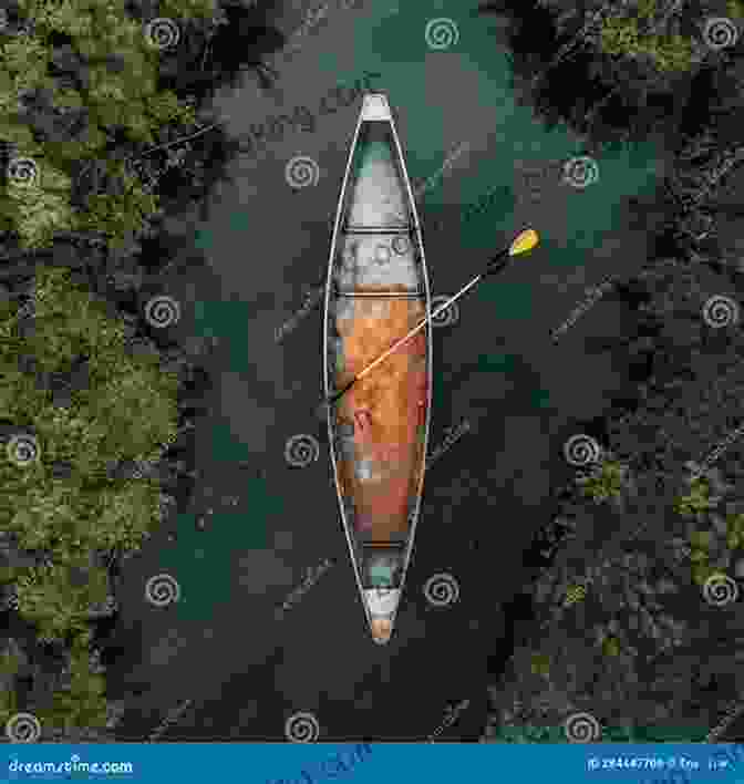 A Wooden Canoe Glides Serenely Across A Tranquil Lake, Surrounded By Verdant Forests From A Wooden Canoe: Reflections On Canoeing Camping And Classic Equipment