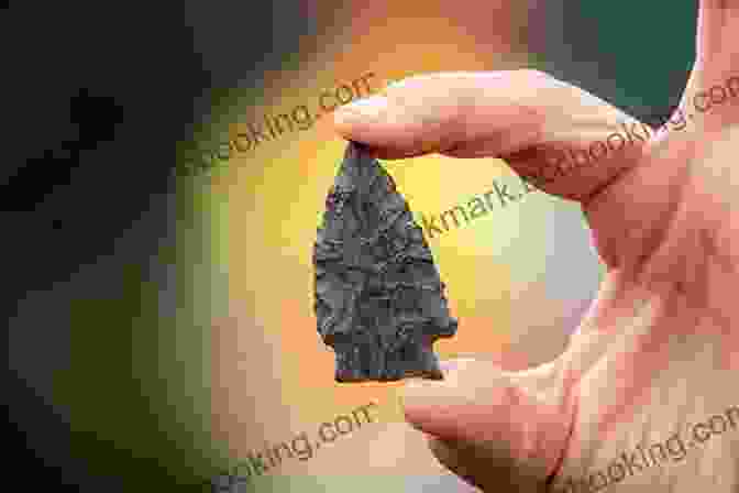 Ancient Stone Arrowhead Found In The Americas, Symbolizing The Book's Exploration Of The Origins Of The Continent's Inhabitants Origin: A Genetic History Of The Americas
